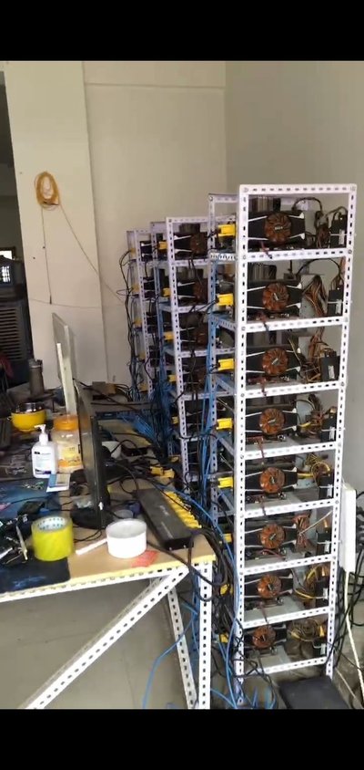 Cryptocurrency mining farm with rows of miners working