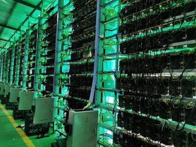 Large-scale Bitcoin mining farm with rows of optimized mining rigs in a climate-controlled warehouse